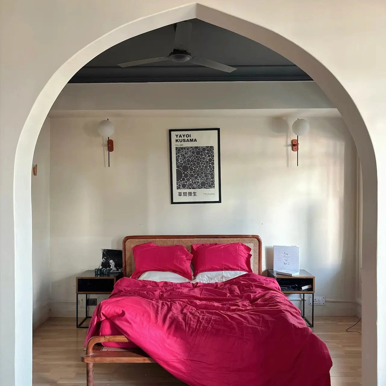 Saanjh Bedroom with lingonberry bedding and a framed picture on the wall.