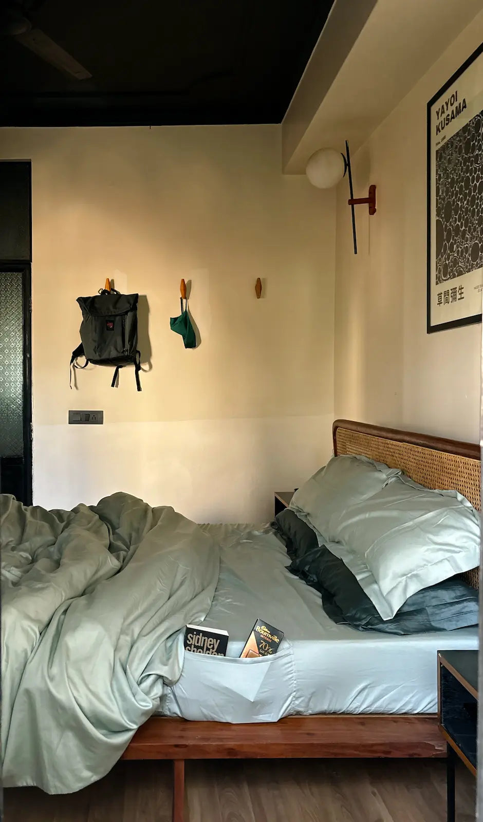 Bedroom with a bed, nightstands, and wall decorations.