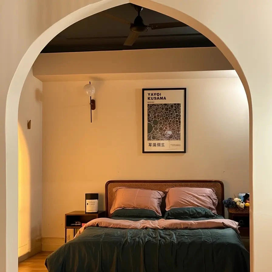 Bedroom with a bed, nightstands, and a framed picture on the wall.