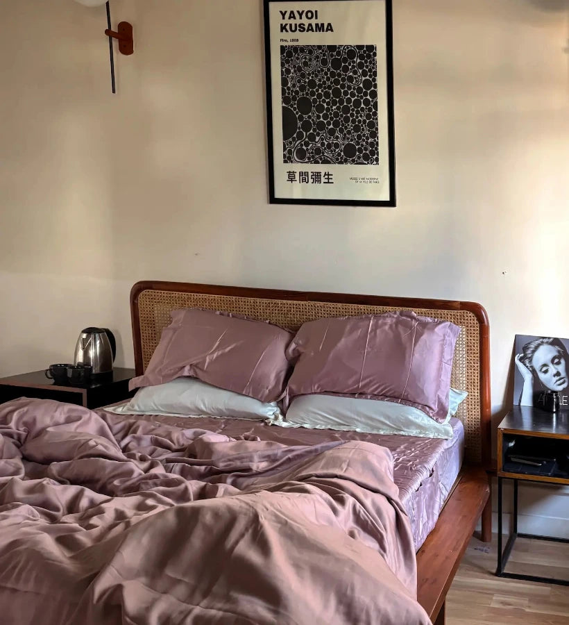 Bedroom with a bed, nightstands, and a wall poster in a room.