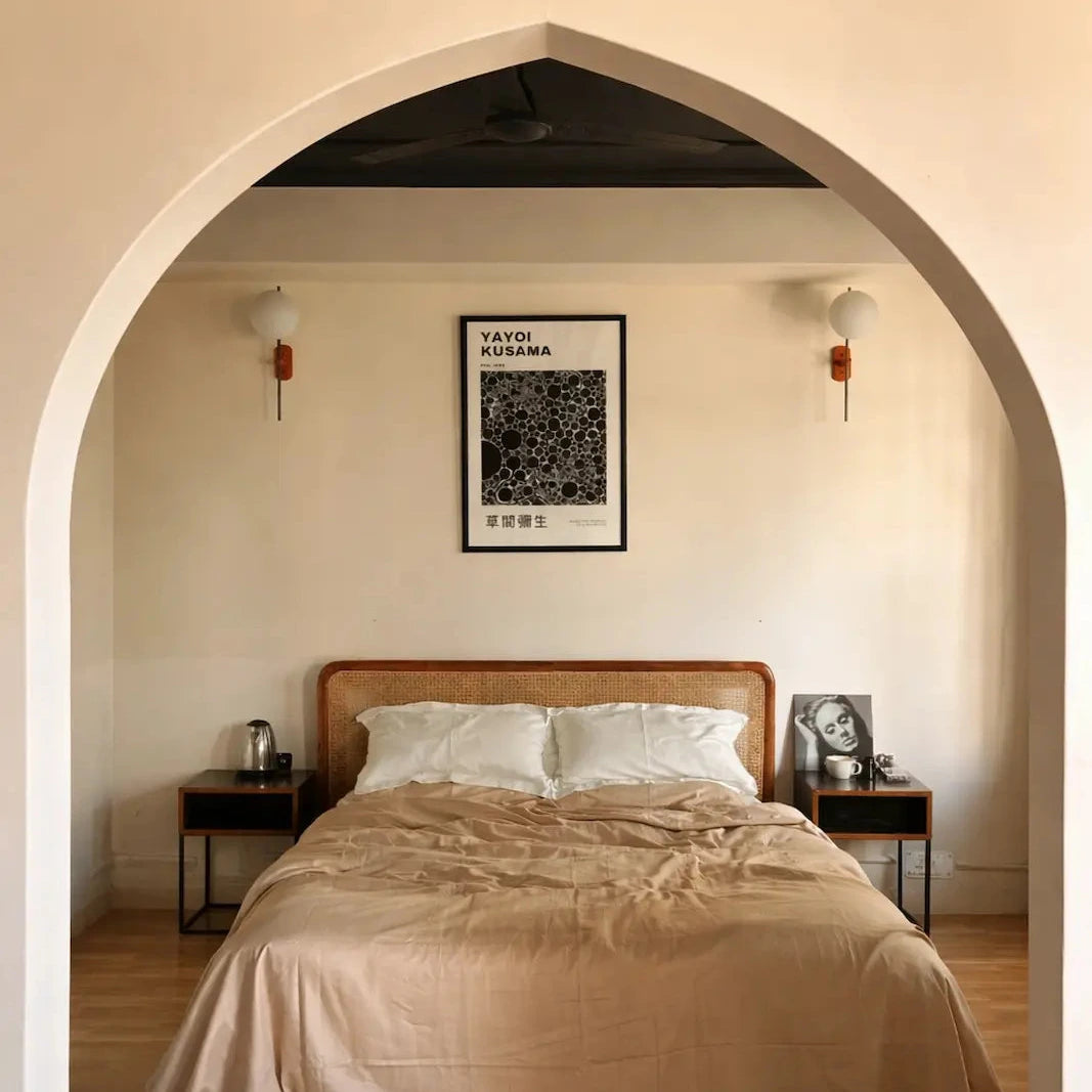Bedroom with a toast and creme bedding, nightstands, and a framed picture on the wall.